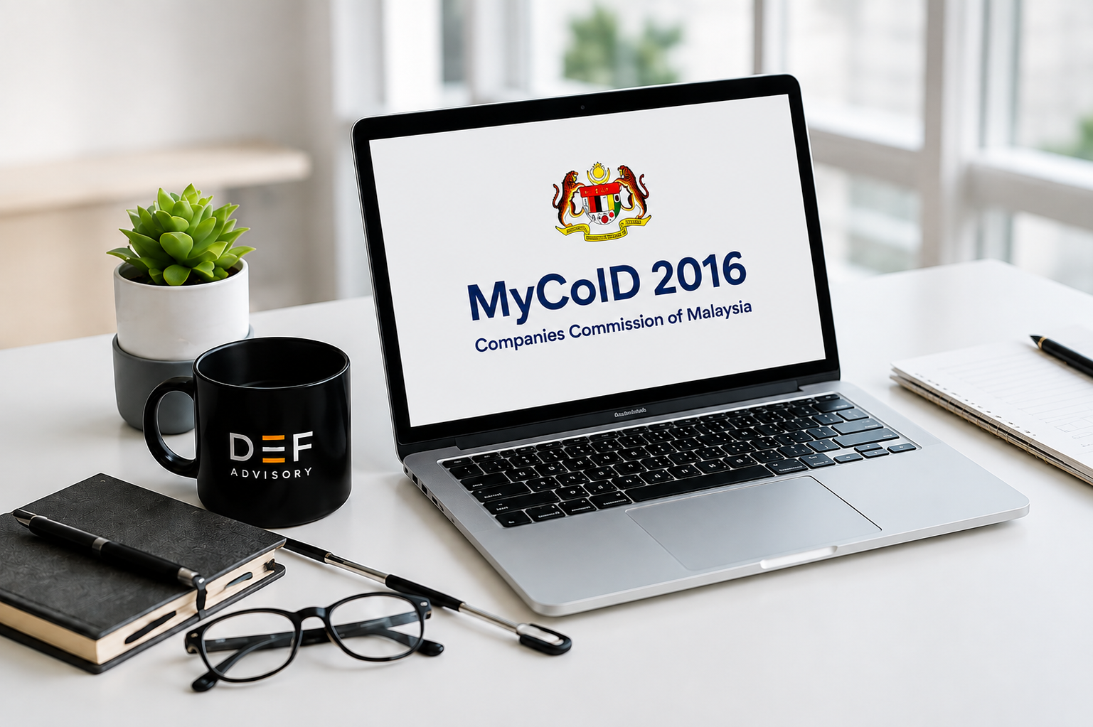 Professional workspace with a laptop displaying the MyCoID 2016 incorporation system